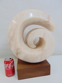 Pink marble spiral form carving on wood base by Arthur Saltzman, sculpture is 17" tall (including