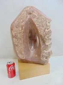 Marble or stone sculpture in pink by Arthur Saltzman, on wood base, sculpture is 21.5" tall, 12.75"