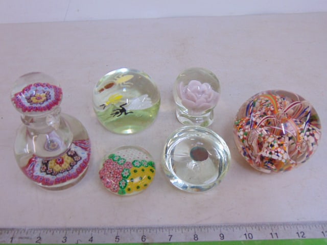 5 art glass paperweights & perfume with stopper, 3 floral designs, one with Indian head penny & one: 5 art glass paperweights & perfume with stopper, 3 floral designs, one with Indian head penny & one with flies, bottle is cracked, paperweight with penny is cracked, perfume is 5.25" tall (with Stoppe