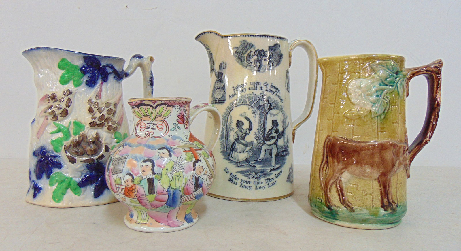 4 pitchers, "I Plays upon de banjo And dey call it Lucy Long", ironstone mug with various scenes: 4 pitchers, "I Plays upon de banjo And dey call it Lucy Long", ironstone mug with various scenes with black musicians & figures, restored, also includes Mason's Patent Ironstone pitcher, glazed pitche