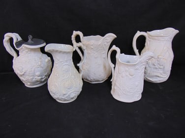 5 Parian & relief molded pitchers, two are repaired, one is missing Pewter lid, tallest one is