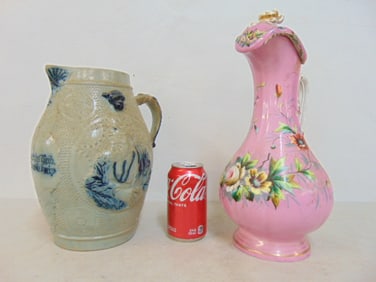 2 pitchers, German salt glaze pitcher with text "je boser das weib je schoner die kneip" with