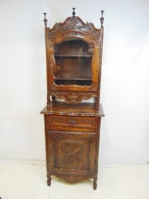 Carved continental two part cabinet with carved detail, top has single glass door, cabinet is not