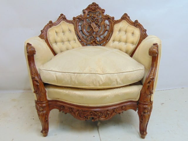 Carved upholstered armchair with elaborate carved back with musical instruments, scrolled arms,: Carved upholstered armchair with elaborate carved back with musical instruments, scrolled arms, chair is 38.5" wide, 30" deep, height is 36", some separation between front skirt and right leg, see ima