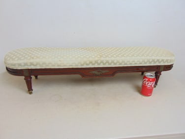 Antique kneeling bench, wood carved base & bronze trim, upholstered top, upholstery is stained,
