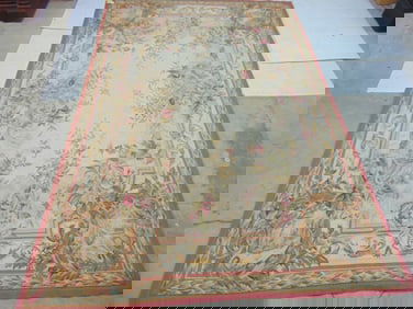Needlepoint rug with floral pattern, pink border, carpet is 8'11" by 5'10"