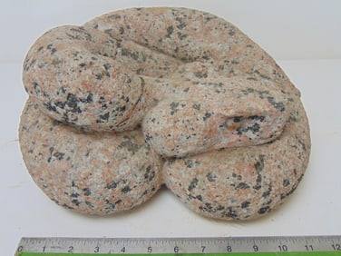 Stone carving, Rattlesnake, by Mark Morrison, in pink speckled granite, coiled snake form, has