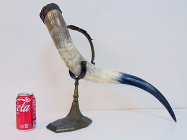 Large drinking horn on brass base with handle, height is 17.25", 20" wide, 8" deep (approx.)