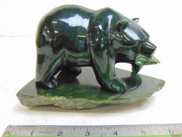 Carved polished green stone Inuit carving of a bear with fish, unsigned, 6.25" by 4.75", height is