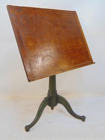 Adjustable drafting table wood top on cast iron base, angle, height adjustable, top is 26" wide,