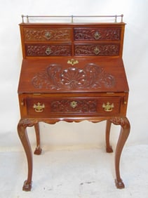 Mahogany slant front desk with carved lid, drawers & brass gallery, Chippendale style, desk is 28"