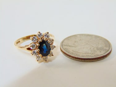 Jewelry. Diamond & Sapphire 14kt ring to include central oval blue stone, faceted stone set in 10