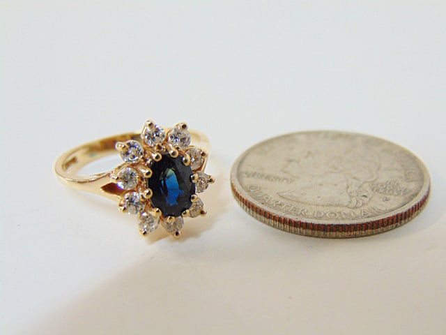 Jewelry. Diamond & Sapphire 14kt ring to include central oval blue stone, faceted stone set in 10 (1 of 4)