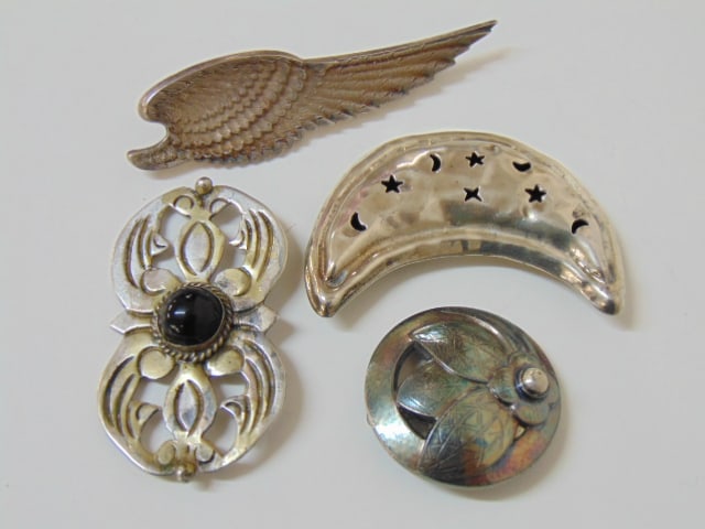 Jewelry. Sterling pins to include Georg Jensen sterling Denmark 127, 0.42 troy oz; Mexico half moon: Jewelry. Sterling pins to include Georg Jensen sterling Denmark 127, 0.42 troy oz; Mexico half moon pin with star & moon cut outs, 925, TG-205, 0.76 troy oz; wing design pin hallmark sterling W & H, 0