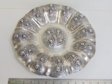 Silver hallmarked tray with raised floral decoration 12.5" in diameter, weight is 20.5 troy