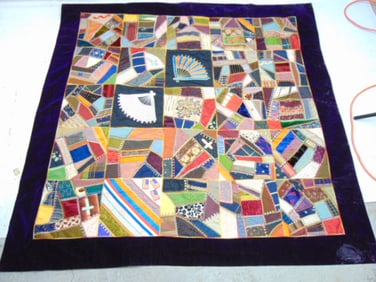 Crazy quilt with purple velvet border, panels decorated with fans, flags, quilt is 64" by 66"