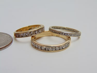 Jewelry. (3) GOLD Diamond bands 14kt to include eternity band, 1.30 grams, size 6; channel set