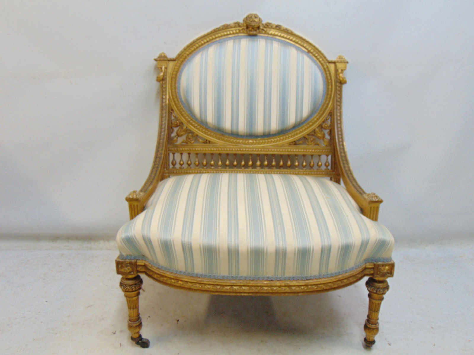 French gilt arm chair with striped upholstery, carved detail on back, arms, good condition, upholste: French gilt arm chair with striped upholstery, carved detail on back, arms, good condition, upholstery clean, chair is 27" wide, 22" deep, height is 35.5"