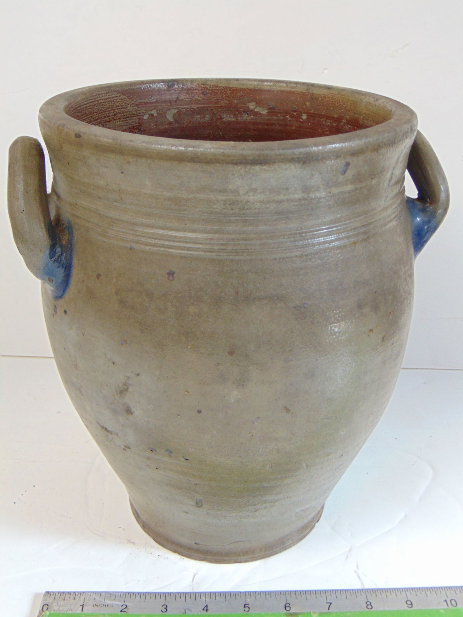Stoneware storage jar. ovoid, blue highlights around open loop handles, several chips around edge (1 of 6)