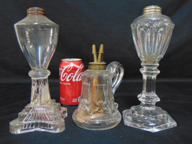 3 antique glass lamps, 2 sandwich glass whale oil lamps & two burner finger lamp with lyre: 3 antique glass lamps, 2 sandwich glass whale oil lamps & two burner finger lamp with lyre decoration, whale lamps are 9" and 9.25", finger lamp is 6 3/8" tall.