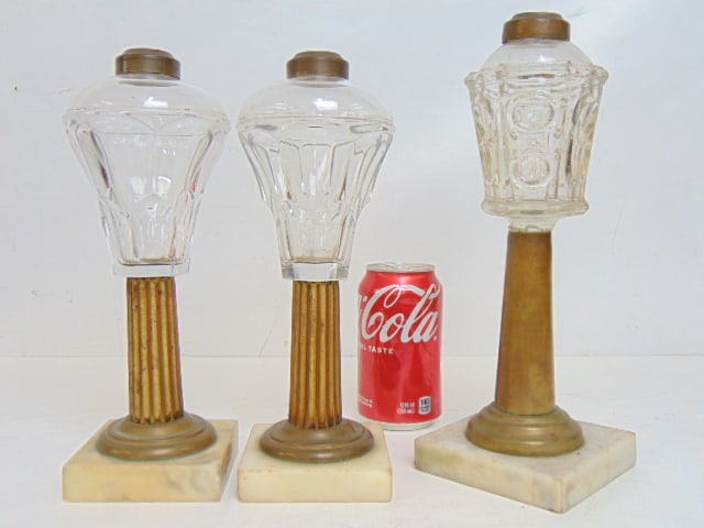 3 whale oil lamps on marble & brass bases, pair & single, brass collars, clear glass reservoirs,: 3 whale oil lamps on marble & brass bases, pair & single, brass collars, clear glass reservoirs, height pair is 10.25", single is 11 2/8" tall.