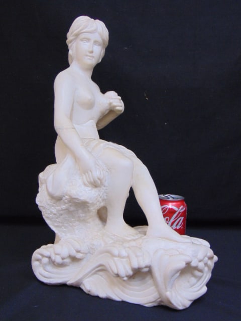 Carved marble statue, woman seated on waves, unsigned, fracture to arm, sculpture is unsigned,: Carved marble statue, woman seated on waves, unsigned, fracture to arm, sculpture is unsigned, 17.25" tall, 11" long, 7" wide.