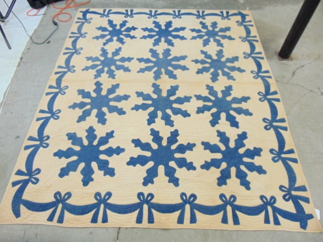 Applique quilt in white with blue ribbon decorations, some stains, 89" by 74": Applique quilt in white with blue ribbon decorations, some stains, 89" by 74"