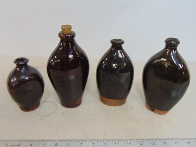 4 redware brown glazed bottles, smallest is 5.5", tallest is 8.25" tall (including cork): 4 redware brown glazed bottles, smallest is 5.5", tallest is 8.25" tall (including cork)