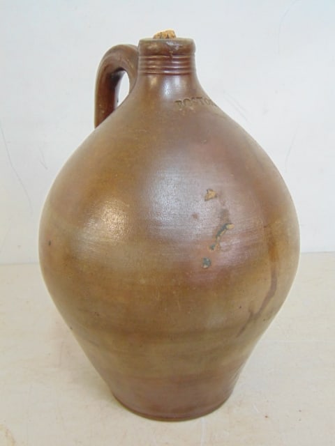 Ovoid stoneware jug, "Boston", in brown, corked, jug is 11.5" tall, 7.75" wide, has hairlines.: Ovoid stoneware jug, "Boston", in brown, corked, jug is 11.5" tall, 7.75" wide, has hairlines.