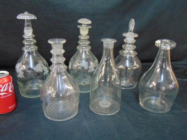 6 antique clear glass bottles, 3 with stoppers, height varies from  9" to 11.5", tallest bottle has (1 of 8)