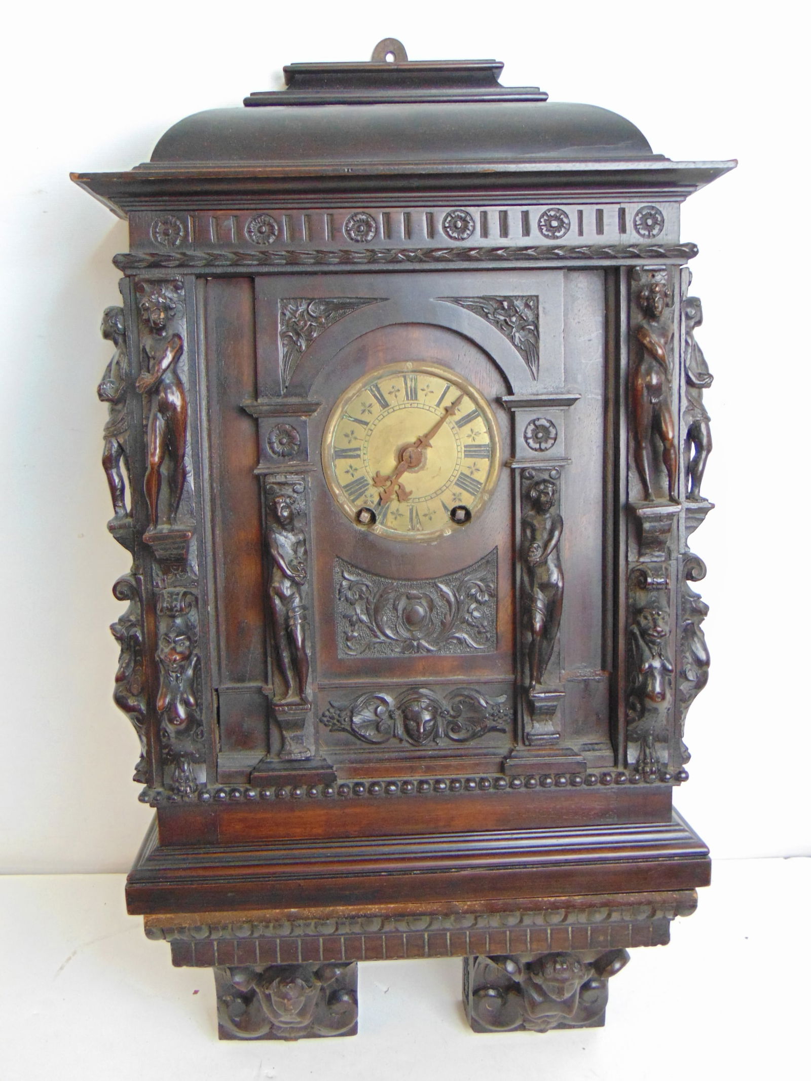 Carved case clock on matching shelf, decorated with carved figures, brass dial, clock is 25.25" tall (1 of 9)