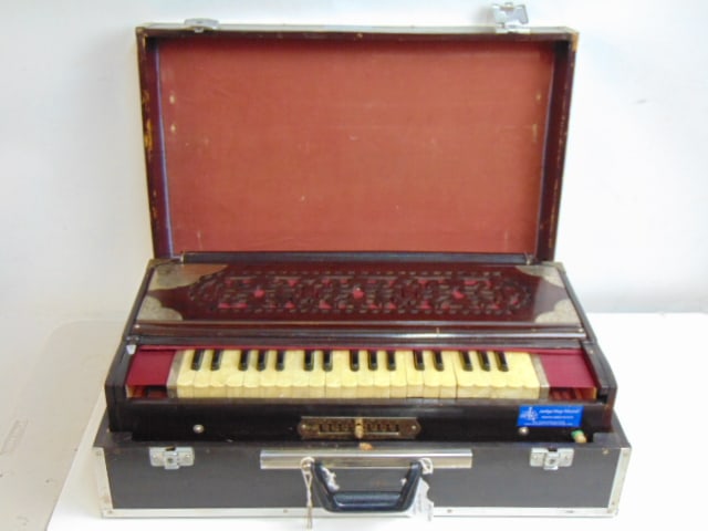 Calcutta folding Harmonium in wood case with metal reinforced corners, plate on corner of instrument (1 of 7)