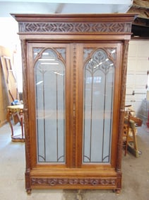 French Gothic revival two door armoire with frosted glass doors, columns decorated with carved leave