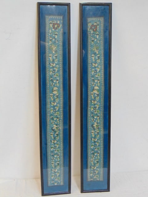 Two Chinese embroidered strips, framed, in blue satin with floral designs, each frame is 35.75" by: Two Chinese embroidered strips, framed, in blue satin with floral designs, each frame is 35.75" by 5.75"