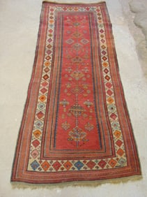 Antique runner rug, appears Kurdish, red with diamond pattern, border, carpet is 9' by 3'10"