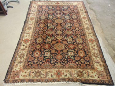 Wool carpet, black with extensive designs, border, probably Indian, rug is 8'7" by 5'10