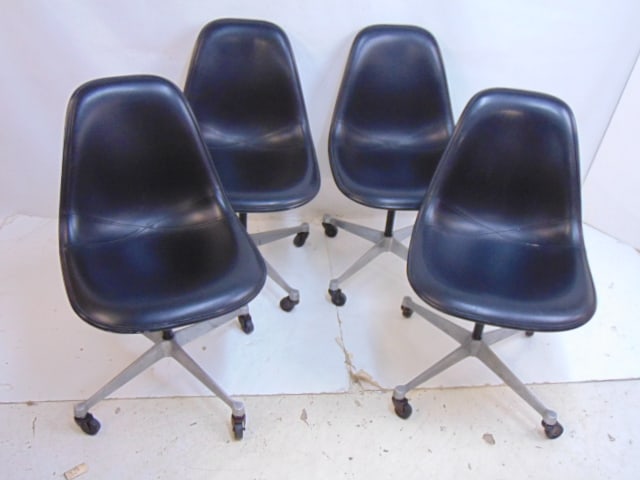 4 Herman Miller swivel chairs, fiberglass shell with black vinyl covering, one chair has small tear (1 of 6)