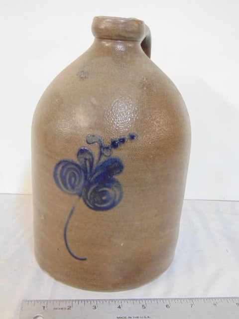 Stoneware jug with floral decoration, has illegible maker mark, height is 11", minor chip on rim: Stoneware jug with floral decoration, has illegible maker mark, height is 11", minor chip on rim