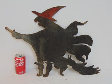 Antique Halloween metal cutout of a flying witch on broom, 25.75" wide, 17.5" tall
