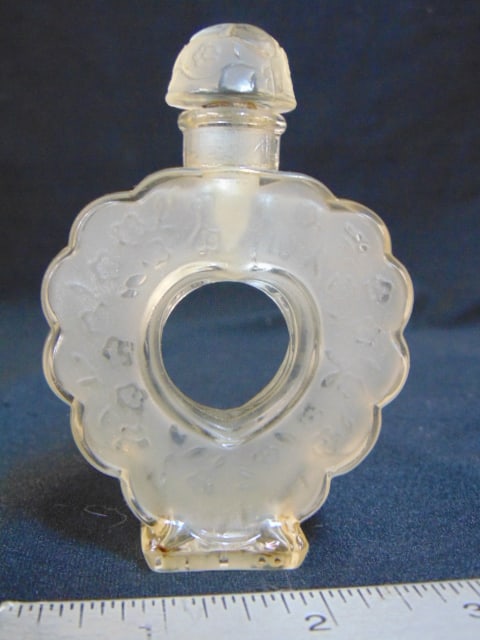 Small Lalique perfume bottle with open center, stopper, height is 4", in good condition.: Small Lalique perfume bottle with open center, stopper, height is 4", in good condition.