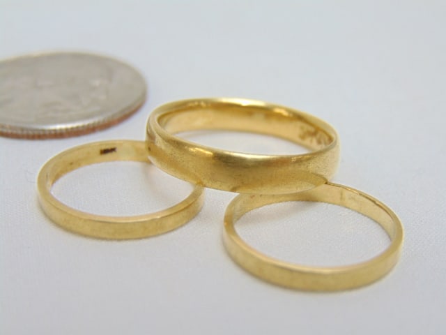 Jewelry. (3) Gold bands, 18kt Tiffany & Co. gold wedding band, 4 grams, size 7 1/2, tested 18kt & (1 of 3)