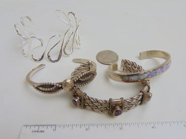 Jewelry. (4) Sterling cuffs/bracelets to include braided cuff w/ 3 amethyst stones; sgd. Nel J.