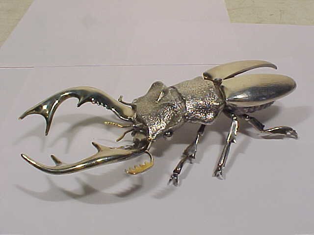 Silver horn beetle, Italian made: Silver horn beetle, Italian made, gold detail, one of the small front antenna is broken and is missing. Beetle is 8.5" long, 3.75" wide (approximately), and 2" tall.