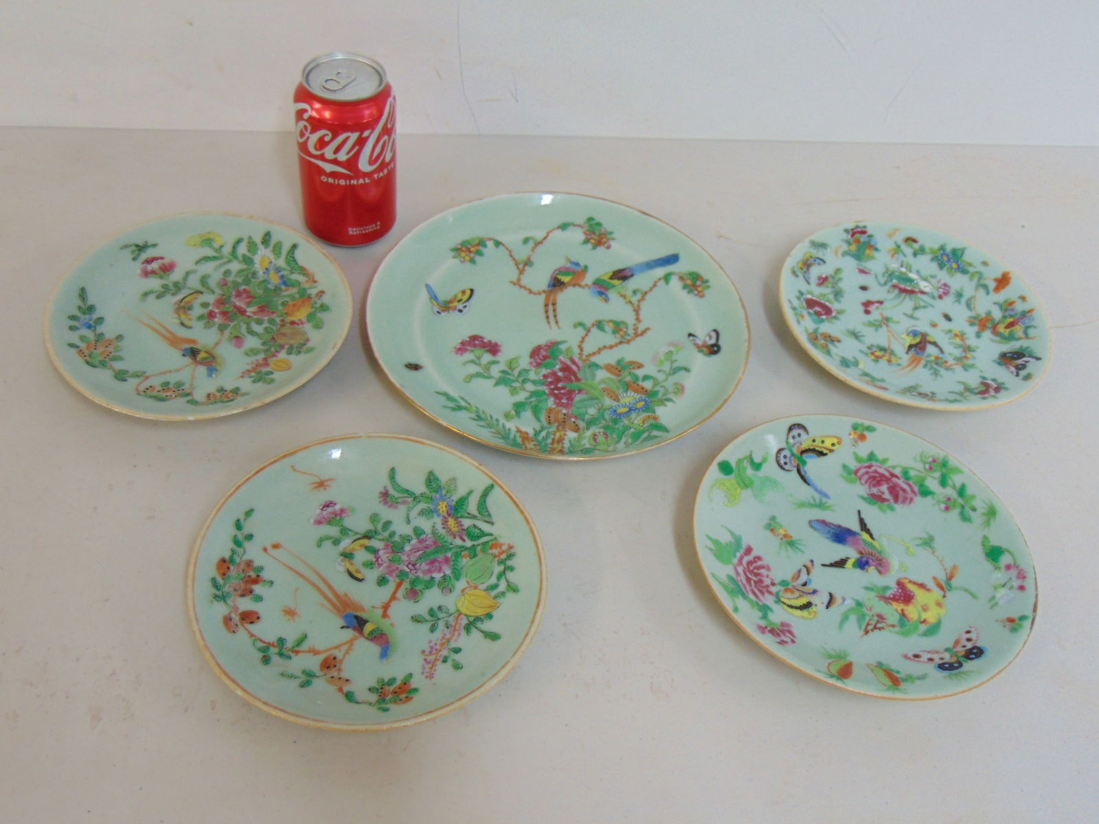 Celadon plates, 4 small plates & one larger, in green with floral, butterfly & bird decoration,