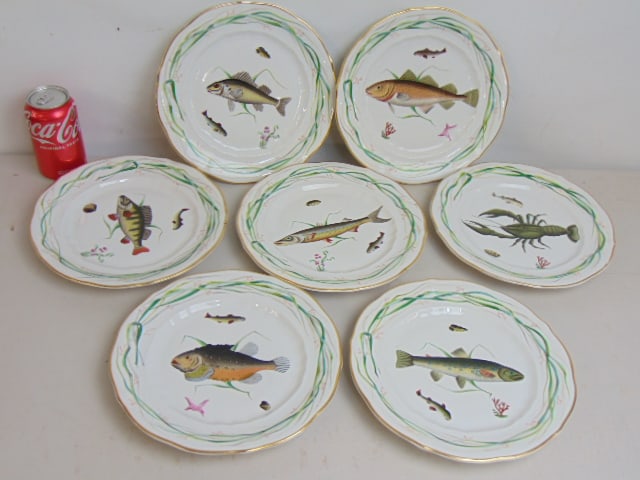 Set 7 porcelain plates with fish decorations, gilt trim, gilt worn in places, unmarked, plates are: Set 7 porcelain plates with fish decorations, gilt trim, gilt worn in places, unmarked, plates are 9.75" in diameter, in good condition.