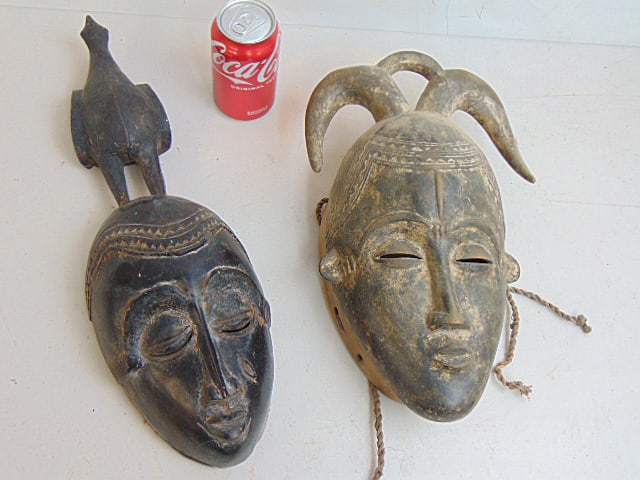 Two African masks, antique Baule buffalo masks, Ivory Coast, one has carved bird on head, 13.75: by (1 of 4)