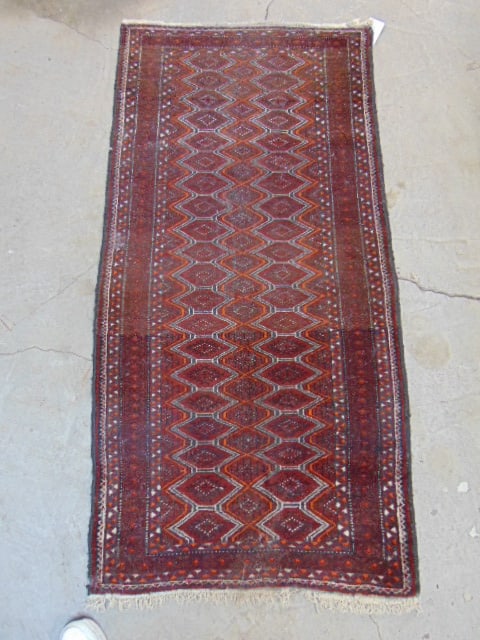 Persian carpet, in red, rug is 67" by 33.5": Persian carpet, in red, rug is 67" by 33.5"
