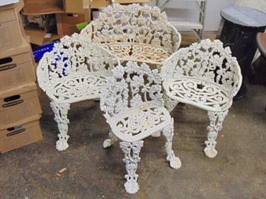 4 piece cast iron patio set with grape vine & grape decorations, 3 chairs & small loveseat,