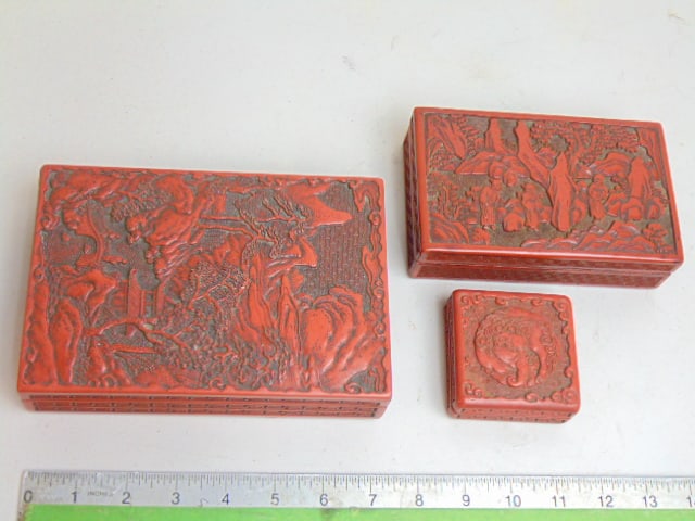 3 Cinnabar boxes, carved detail, largest is 7.,5" by 5", smallest is 2.75" by 2.75": 3 Cinnabar boxes, carved detail, largest is 7.,5" by 5", smallest is 2.75" by 2.75"
