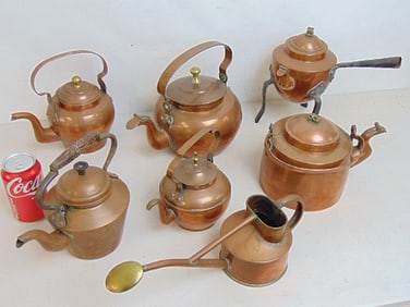 6 antique copper tea kettles & copper & brass watering can, one tea kettle has iron legs, watering